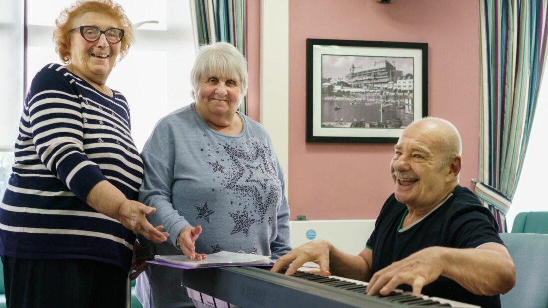 two ladies enjoying a music session with a keyboard